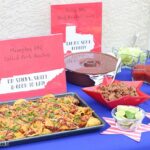 A beautifully arranged food table with various BBQ dishes, perfect for a Memorial Day party.