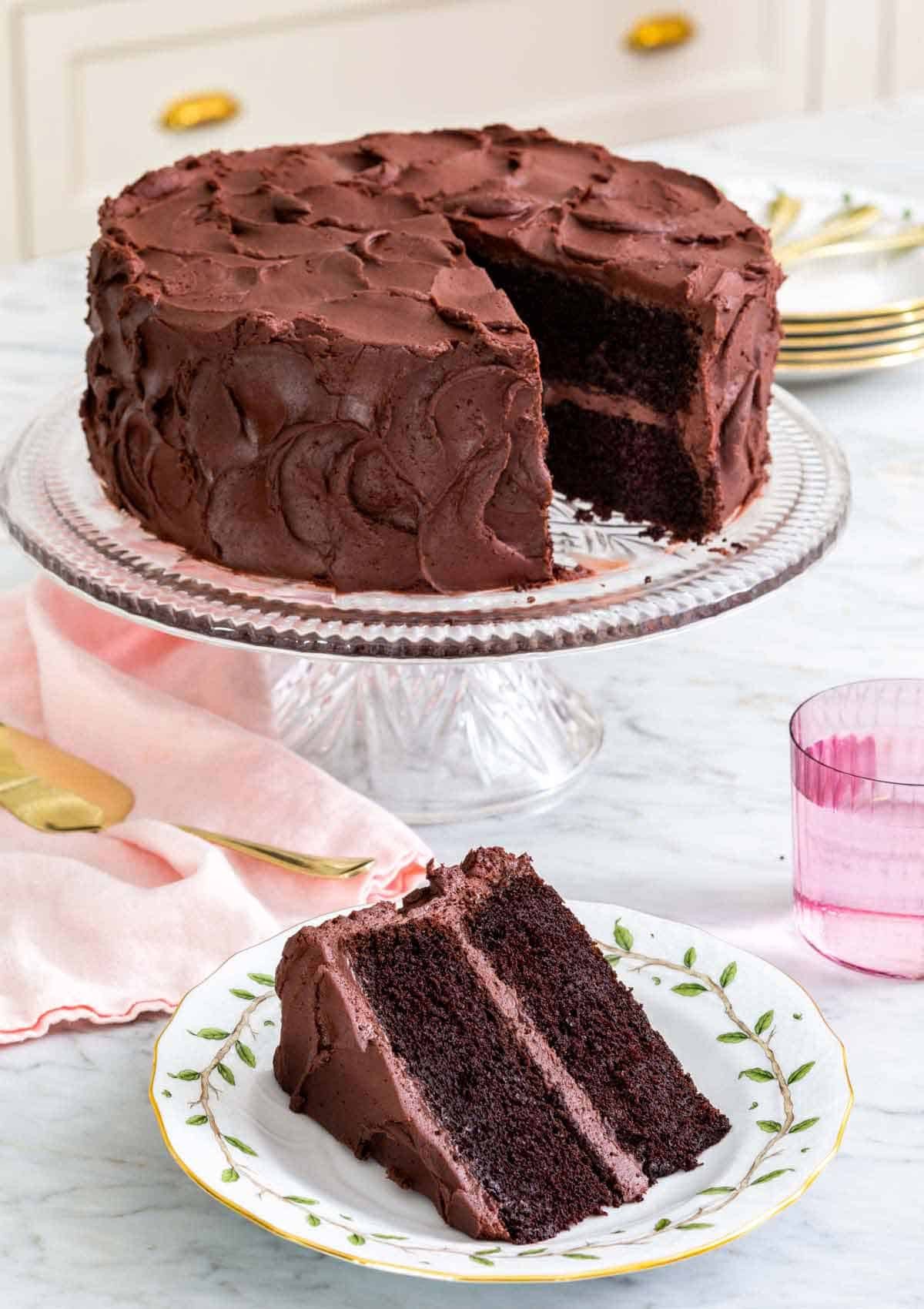 A devil's food cake on a cake stand, showcasing its rich chocolate frosting and tempting appearance.