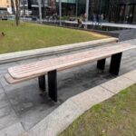 A long bench with a second tier above it and offset to act as a sort of table.