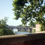 A picturesque street in Toulouse showcasing traditional terracotta buildings.