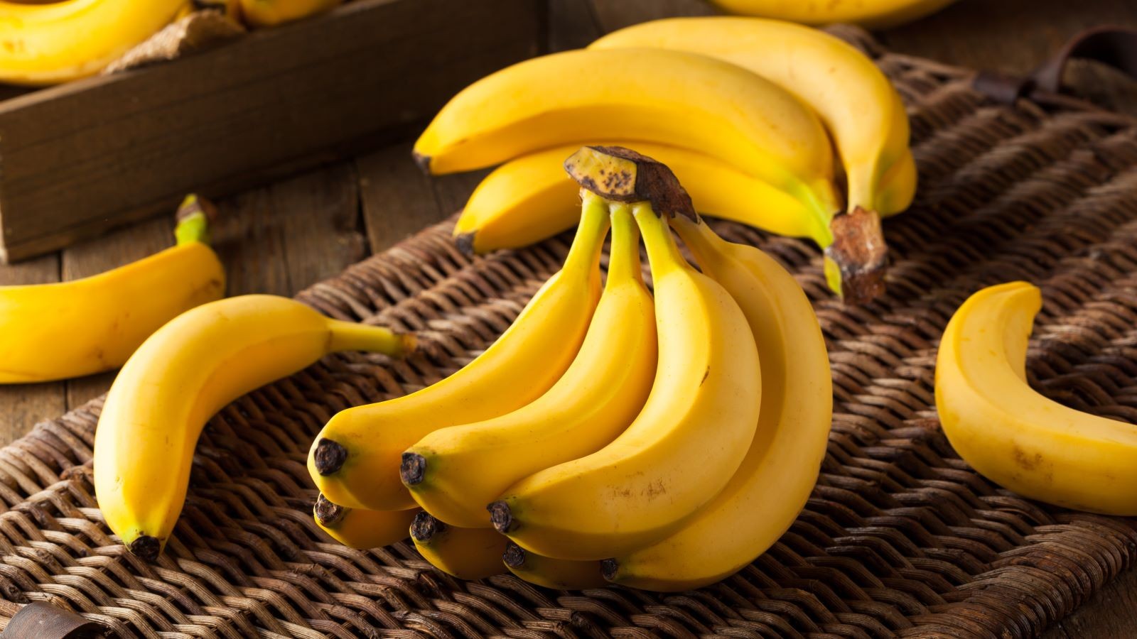 A selection of foods that help with nausea, including toast, bananas, and ginger tea, arranged on a kitchen counter.