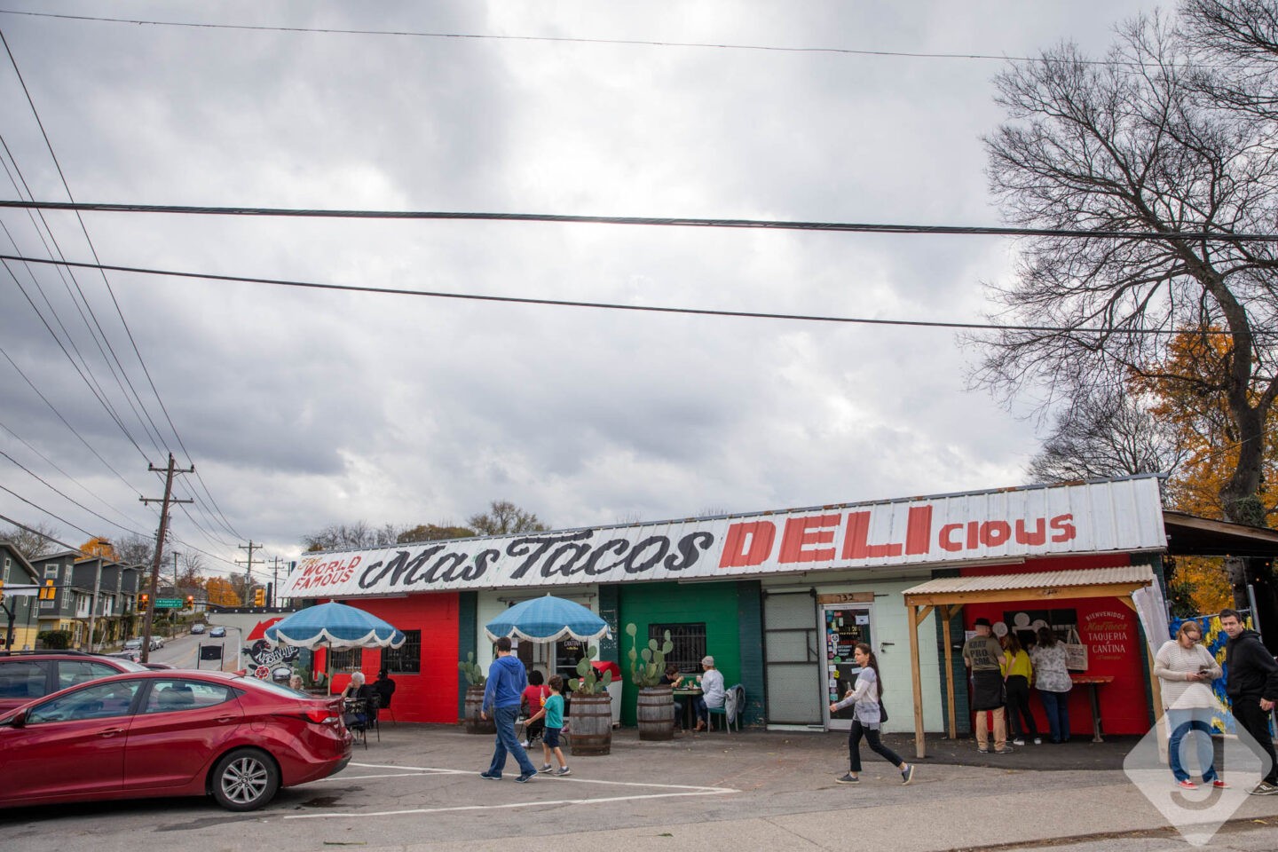 A vibrant and colorful interior shot of Mas Tacos Por Favor, showcasing its lively atmosphere in East Nashville