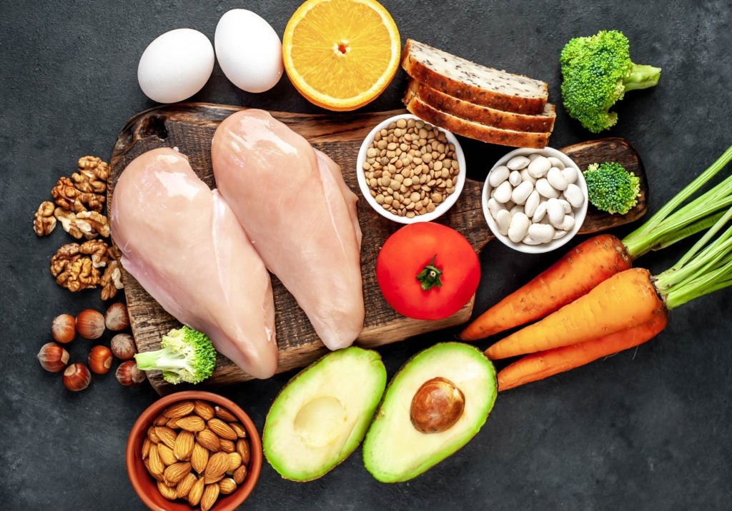 A vibrant array of foods rich in niacin, including chicken breast, tuna, peanuts, lentils, brown rice, and avocado, highlighting diverse dietary sources of vitamin B3.