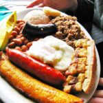 A vibrant Bandeja Paisa, a quintessential Colombian food platter, showcasing the country's rich culinary heritage.