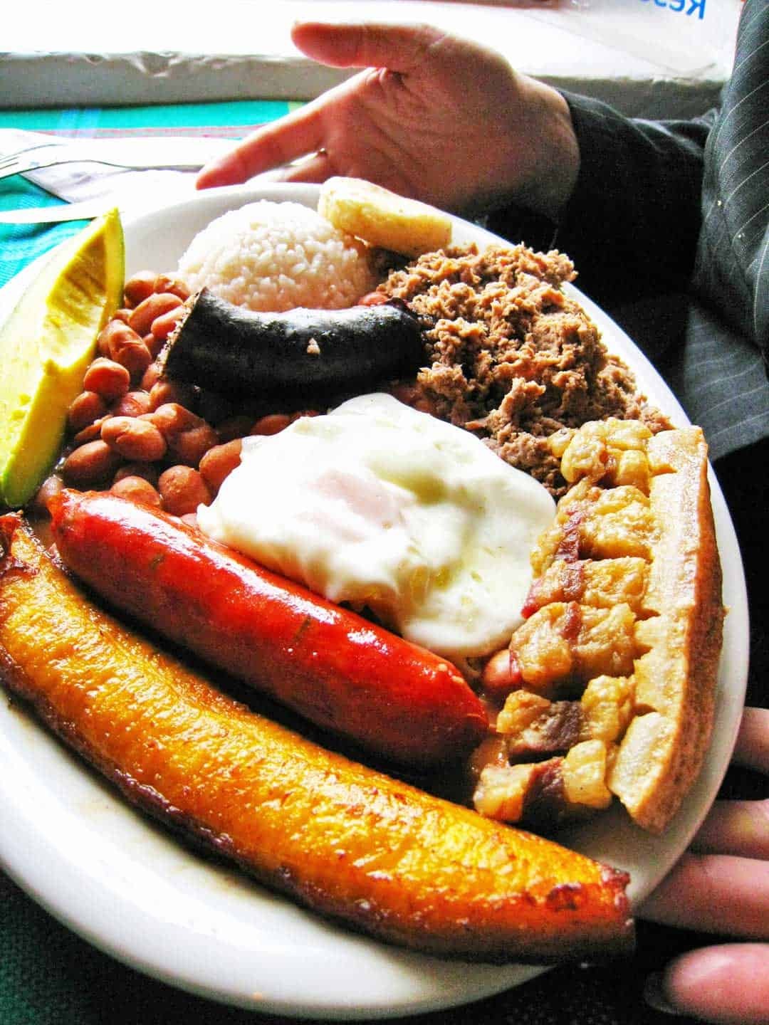 A vibrant Bandeja Paisa, a quintessential Colombian food platter, showcasing the country's rich culinary heritage.