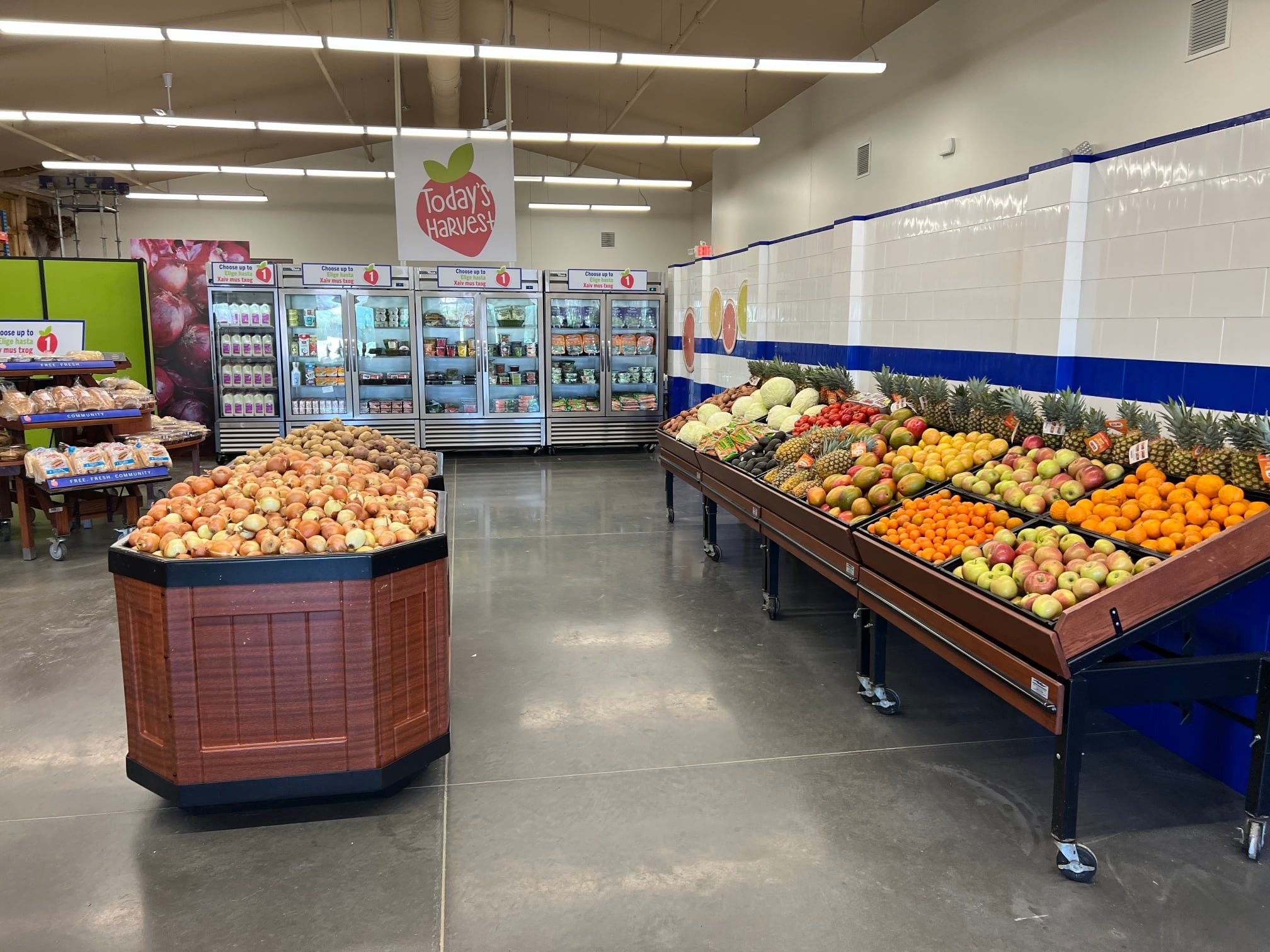 A vibrant display of fresh produce and groceries at Today's Harvest, emphasizing the variety of food open today.