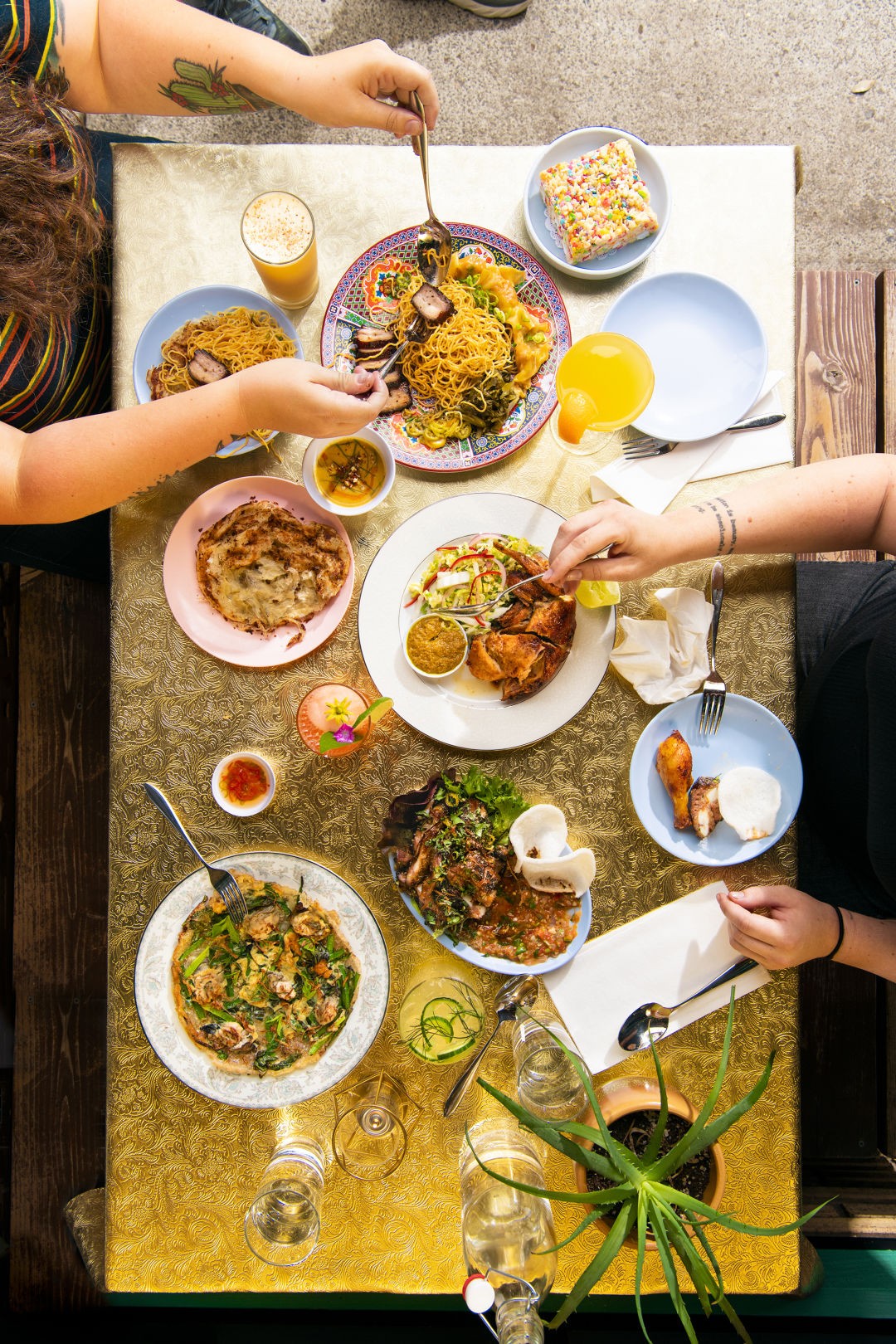 A vibrant spread of dishes at Oma's Hideaway, showcasing Malaysian culinary diversity.