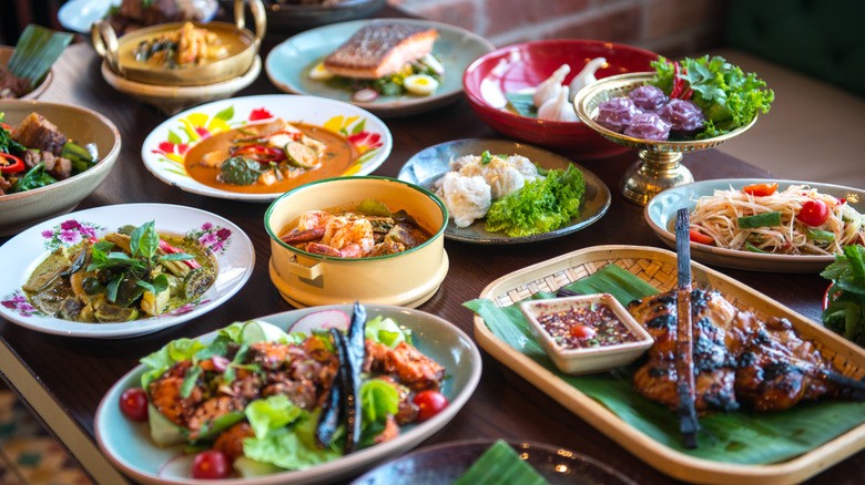 A vibrant table spread of various Thai dishes