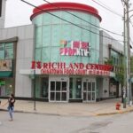 A wide shot of the Richland Food Court interior, showing various food stalls and customers