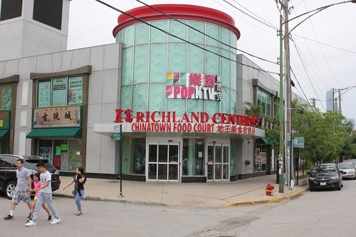 A wide shot of the Richland Food Court interior, showing various food stalls and customers