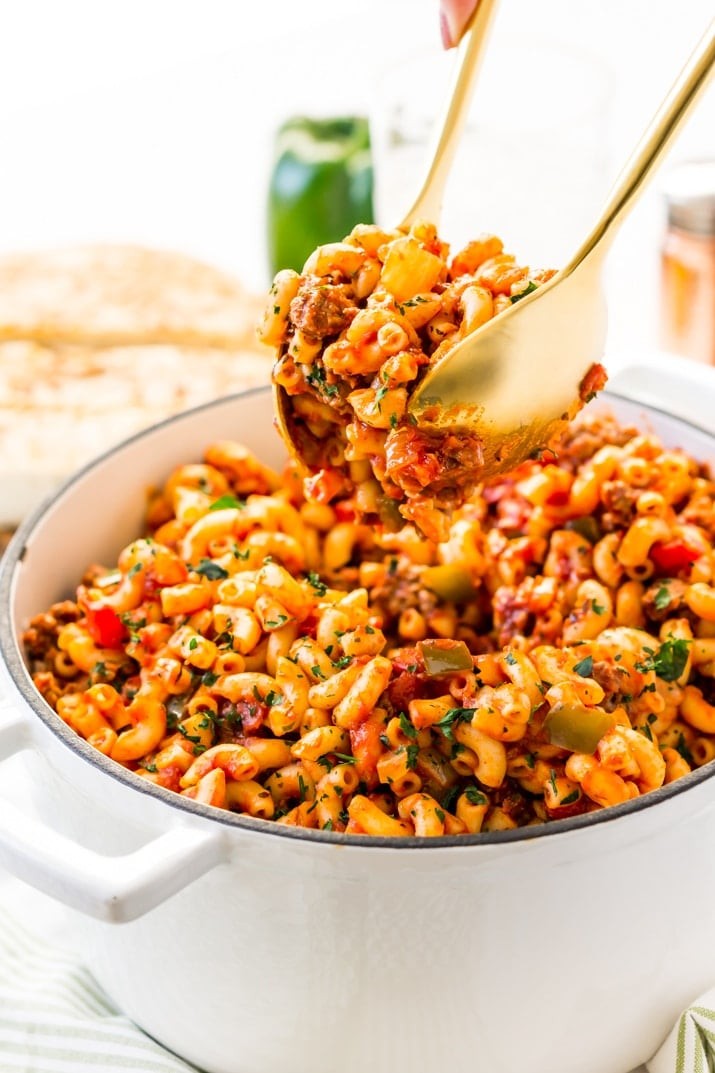 American Chop Suey, a comforting and straightforward dinner, combines ground beef, tomatoes, onions, green peppers, macaroni, and spices. This stovetop classic is ready in 30 minutes, perfect for a quick weeknight meal!