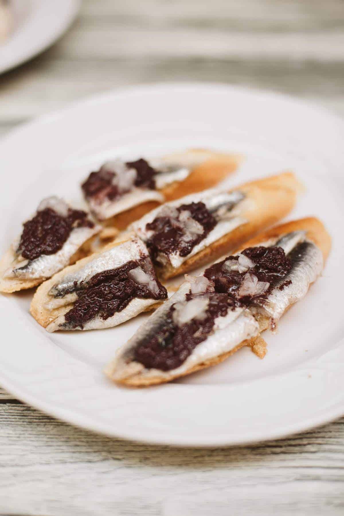 Anchovies with black olive tapenade served as pintxos in San Sebastian.