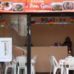 Assortment of Haitian dishes featuring rice, fried plantains, and meats