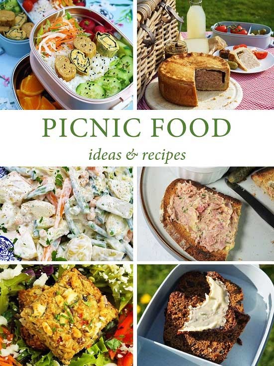 Assortment of picnic food laid out on a blanket in a park