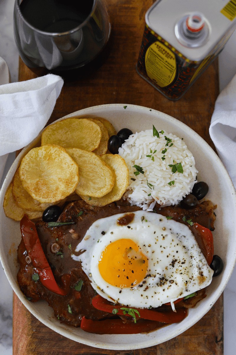 Bitoque, a Portuguese steak topped with egg, served with rice and fried potatoes, popular in Cape Verde food