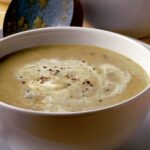 Bowl of B'ssara, a traditional Moroccan broad bean soup, garnished with olive oil and cumin