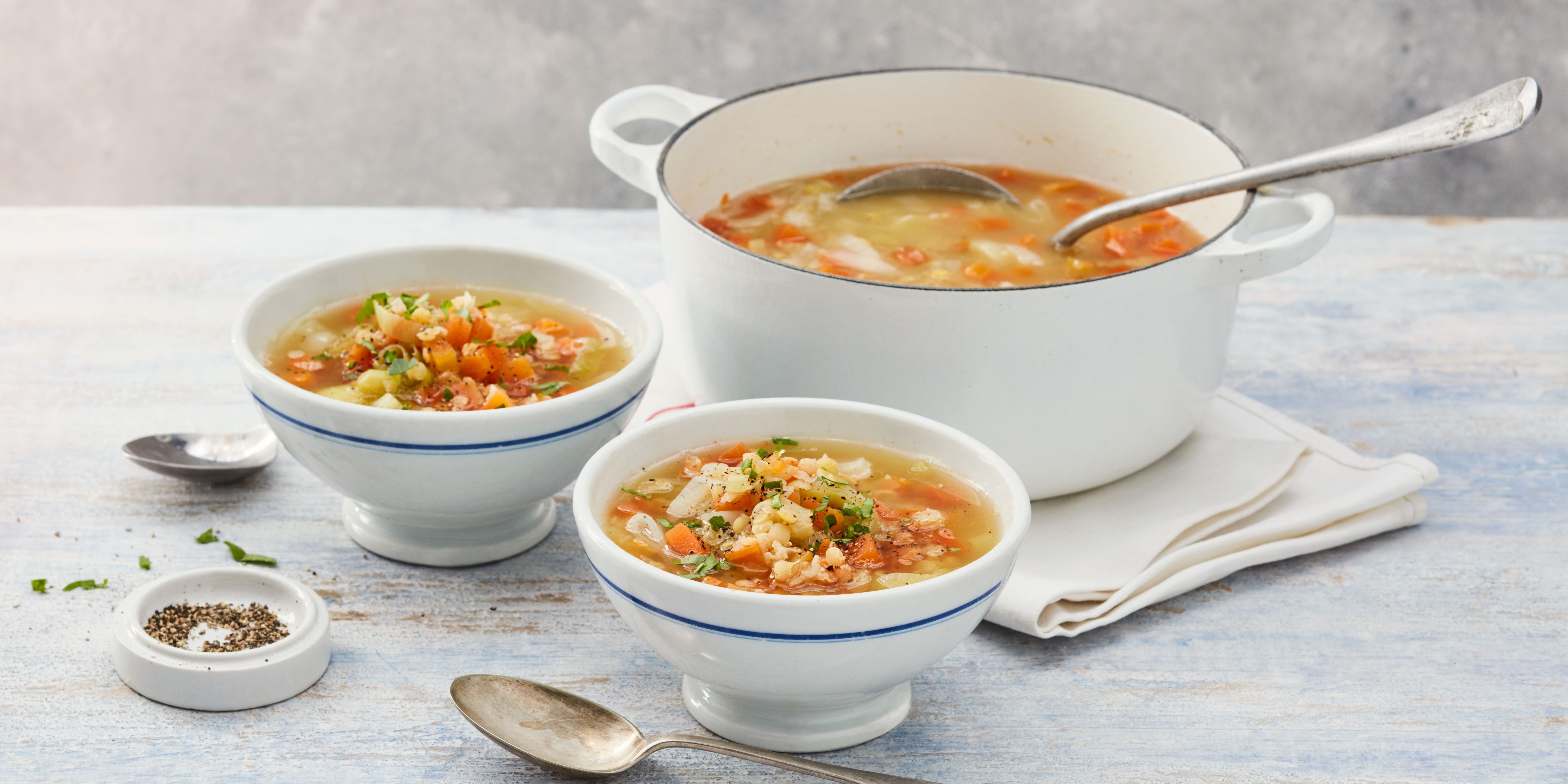 Bowl of lentil soup with visible lentils, carrots, and parsley, suggesting a healthy and simple lunch option.