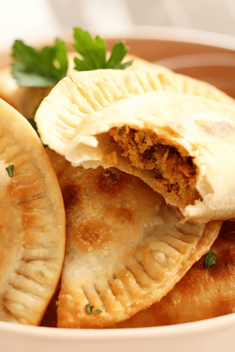 Cape Verdean pastel with savory tuna filling visible, a popular Cape Verde food snack