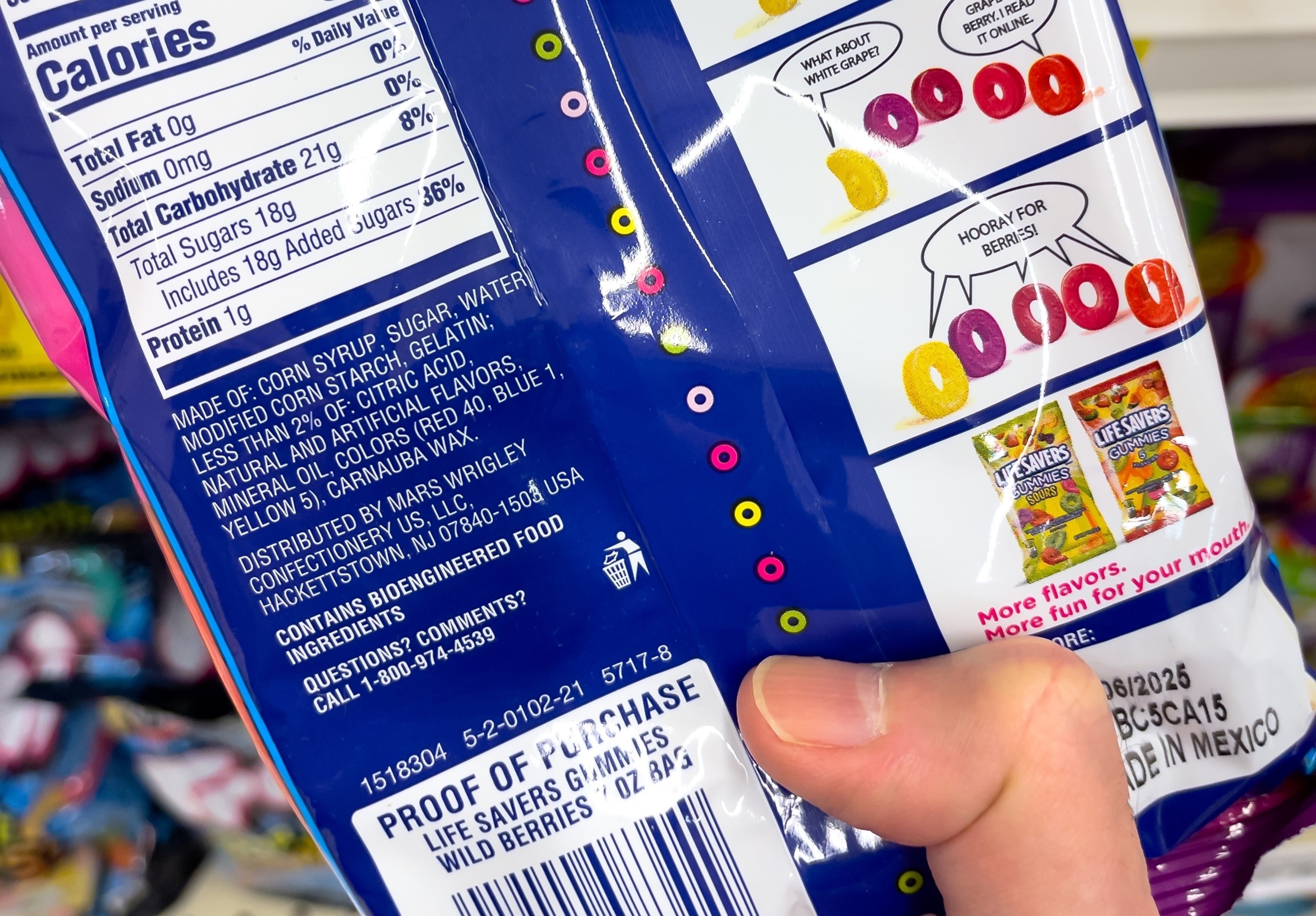 Close-up of a candy ingredient label highlighting Red Dye 40, Blue 2, and Yellow 5, common artificial food colorings in processed foods.