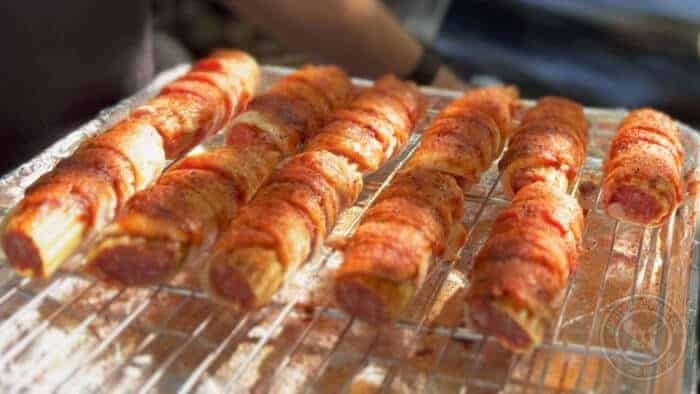 Close-up of bacon-wrapped shotgun shells, showcasing the crispy bacon and cheesy filling.