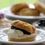 Close-up of blackcurrant jam and scones, essential tea party food