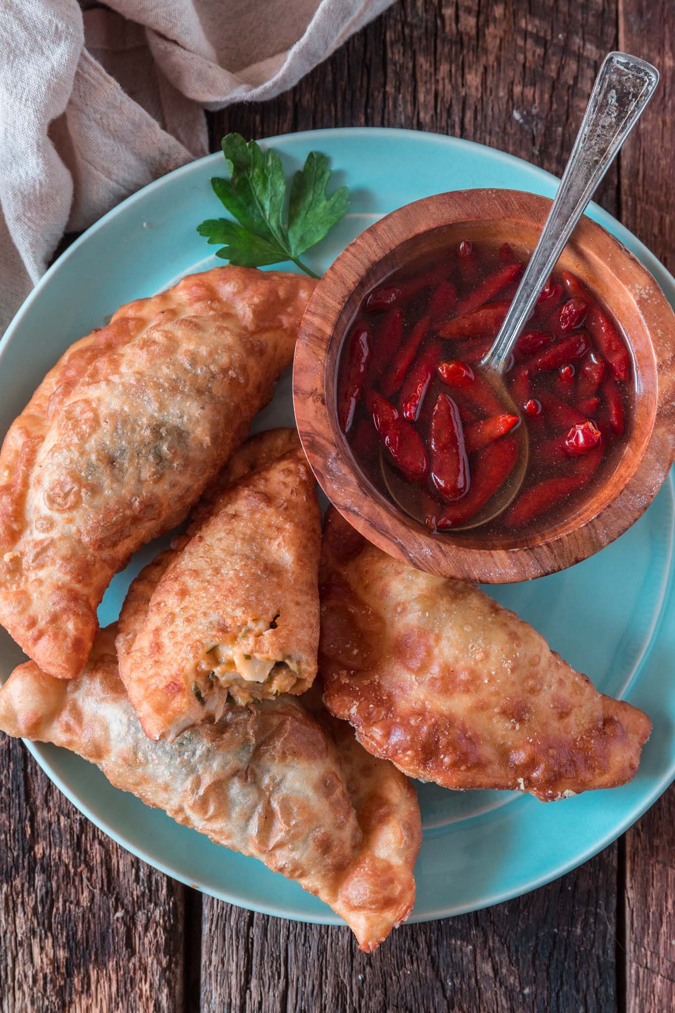 Close-up of golden brown Brazilian pastel with various savory fillings, a popular and delicious street food.