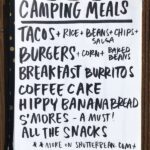 Close-up of taco ingredients laid out on a picnic table, ready for a camp taco night.