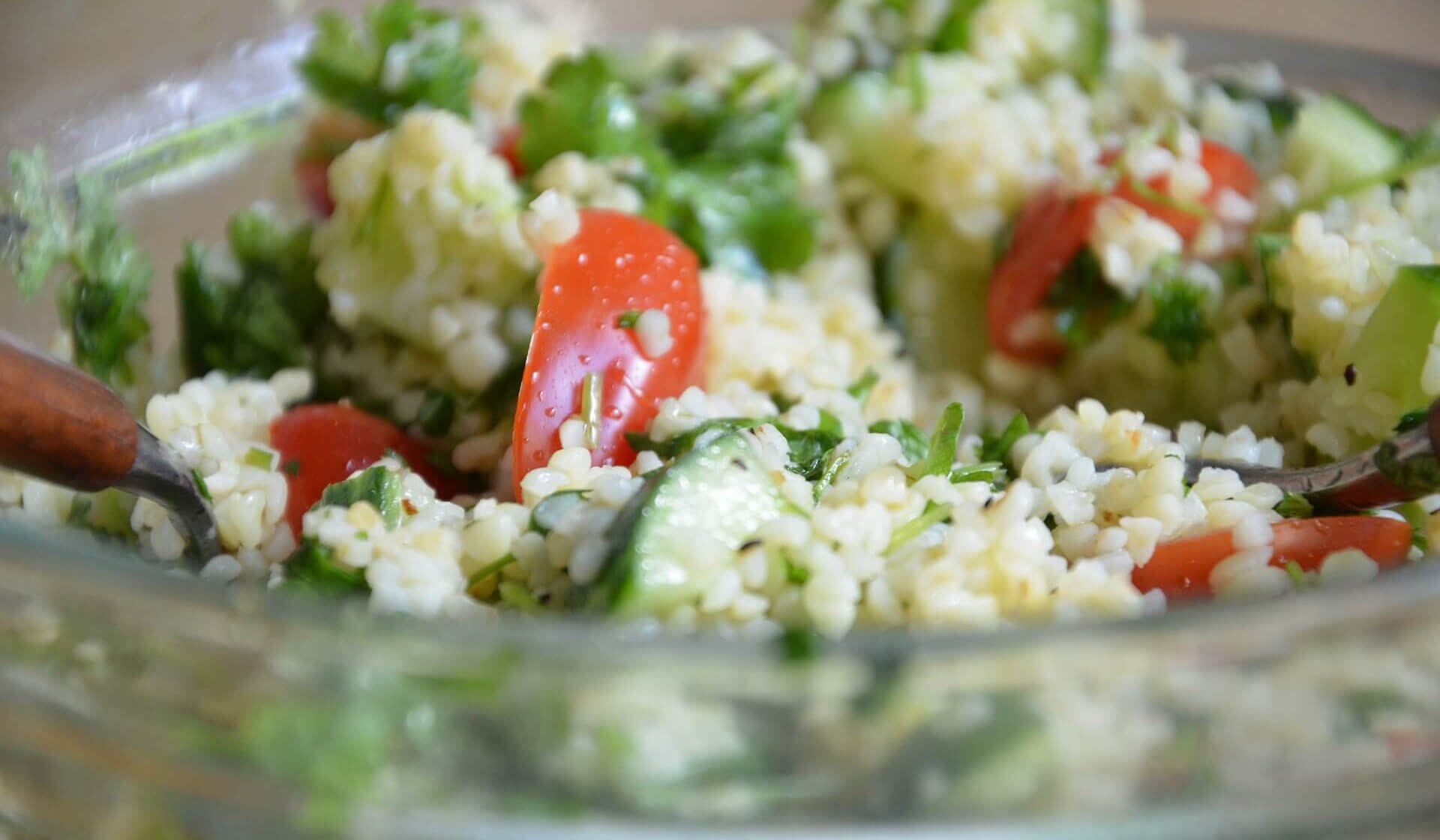 Close-up of vibrant Lebanese Tabbouleh salad showcasing fresh parsley, tomatoes, mint, and bulgur wheat.