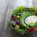 Close-up shot of a vibrant salad in a white bowl, showcasing fresh ingredients and backlighting