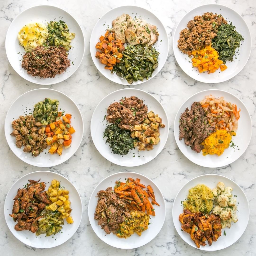 Close-up shot of Pete's Paleo meal featuring pork chops, sweet potato hash and greens, showcasing fresh ingredients and balanced portions.