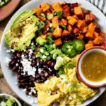 Close-up shot of vibrant vegan breakfast bowls filled with roasted sweet potatoes, Just Egg scramble, black beans, and avocado, perfect for those searching for vegan breakfast food near me