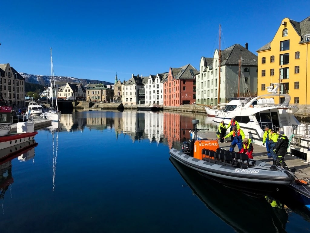 Colorful buildings in Alesund Norway reflecting on waters