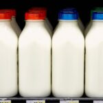 Colorful drinks and milk in glasses, representing food and beverage products that may contain food dyes.