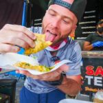 David Hoffmann enthusiastically enjoying Trinidad doubles at Sauce Team, a must-try food spot in Trinidad | Davidsbeenhere