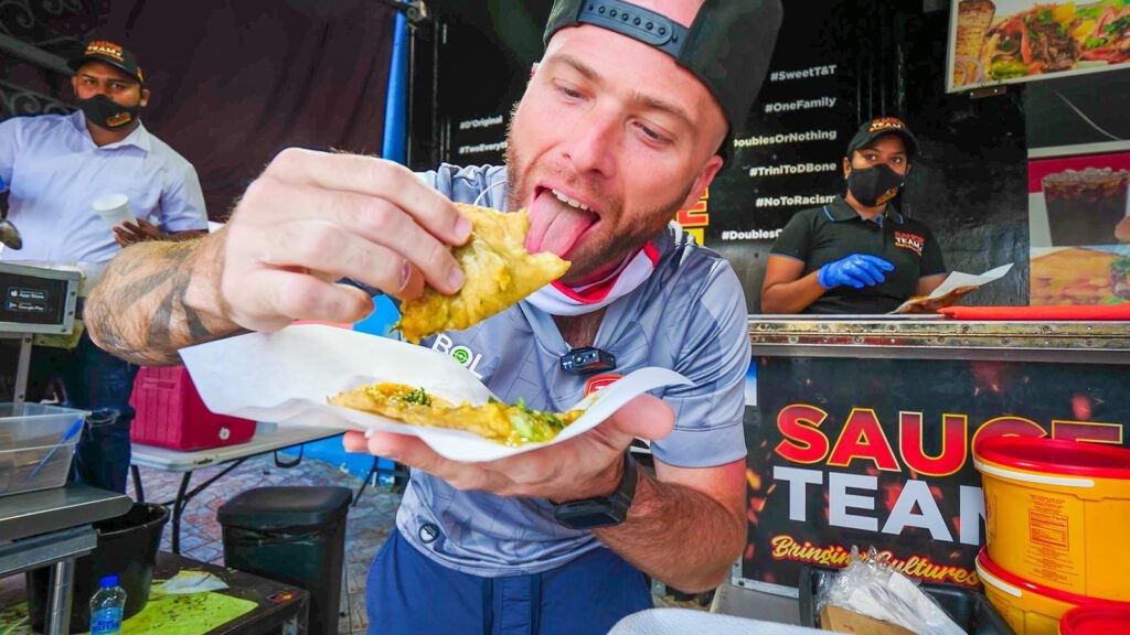 David Hoffmann enthusiastically enjoying Trinidad doubles at Sauce Team, a must-try food spot in Trinidad | Davidsbeenhere