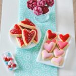 Delicate miniature Valentine's Day heart cookies crafted from polymer clay, arranged on a petite dollhouse table.