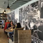 Expanded interior of Tres Market Foods, showcasing seating and food displays