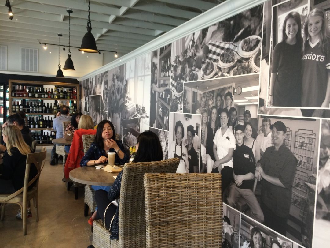 Expanded interior of Tres Market Foods, showcasing seating and food displays