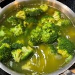 Fresh broccoli florets being prepared for a homemade dog food recipe, highlighting the natural green color and healthy texture of the vegetable.