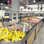 Fresh produce section at Hung Vuong Supermarket showcasing a wide variety of colorful fruits and vegetables.