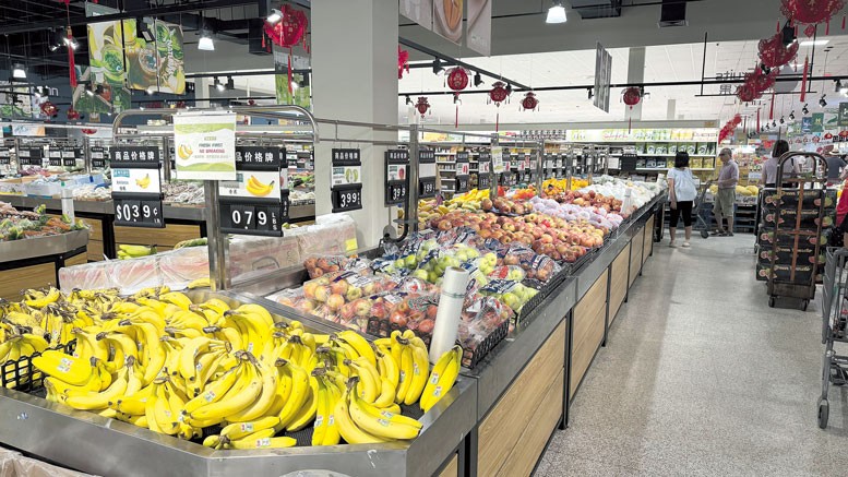 Fresh produce section at Hung Vuong Supermarket showcasing a wide variety of colorful fruits and vegetables.