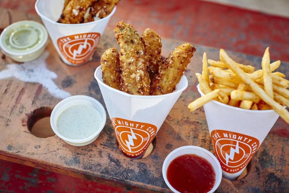 Fried chicken and fries in a cone from The Mighty Cone food truck, showcasing innovative food presentation in Austin's catering scene.