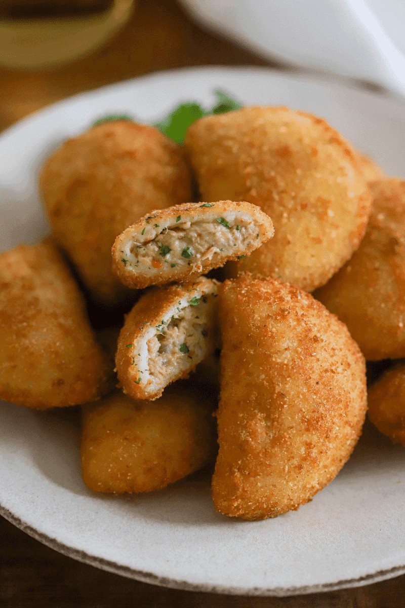 Fried tuna rissois, Cape Verde food seafood turnovers, with filling visible