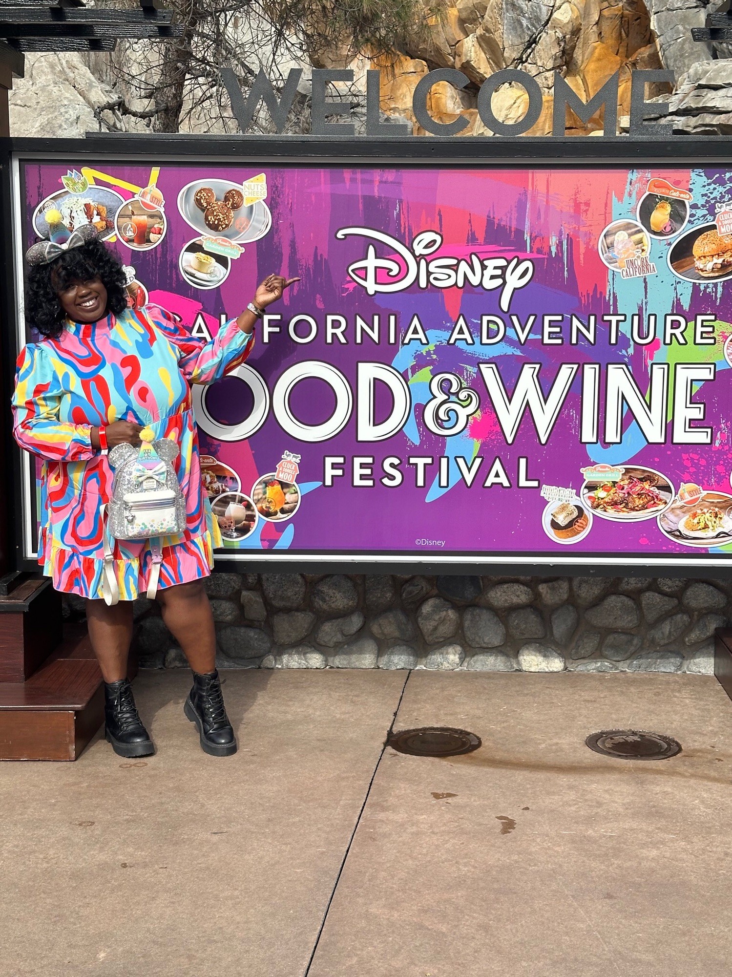 Guests enjoying the vibrant atmosphere of the Disneyland Food and Wine Festival 2024, exploring various food booths and tasting culinary delights.