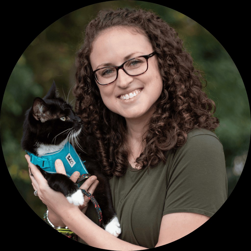 headshot of Emily Hall, certified cat trainer, holding her cat Sampson