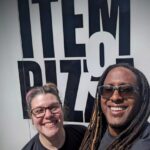 Jonathan Traylor and his wife Kellie, founders of Item9 Pizza, standing proudly in front of their pizza food truck, ready to serve the Raleigh community.