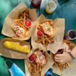 Lobster roll at Abel's Lobster in Mount Desert, Maine, showcasing generous filling and toasted roll, a top choice for dinner food near me.