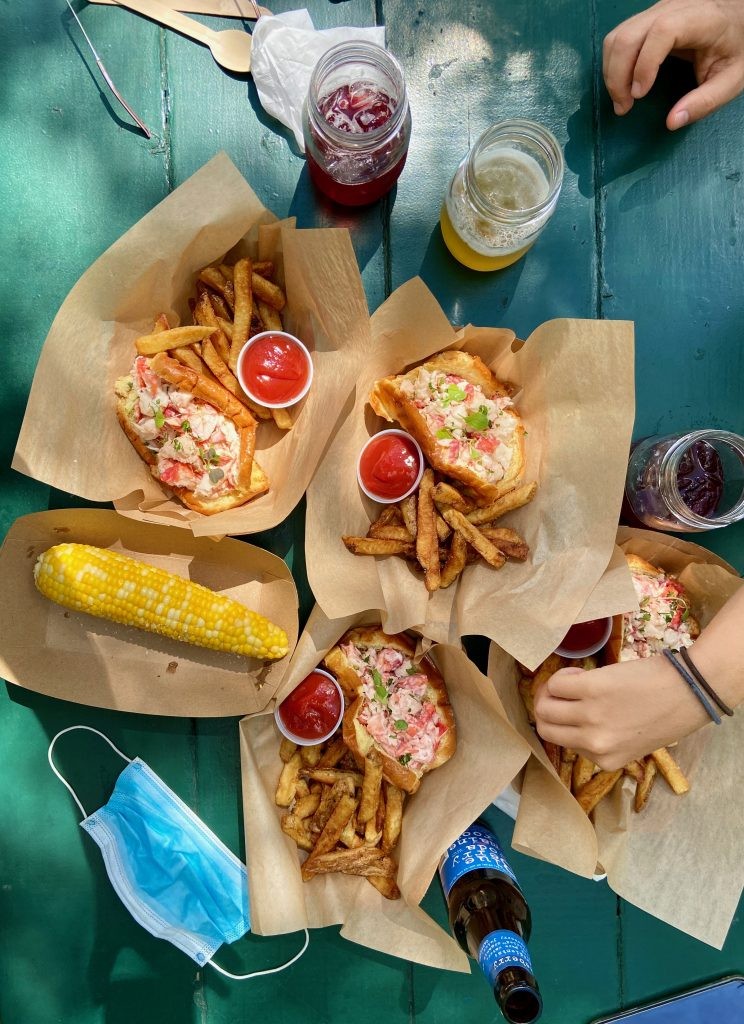 Lobster roll at Abel's Lobster in Mount Desert, Maine, showcasing generous filling and toasted roll, a top choice for dinner food near me.