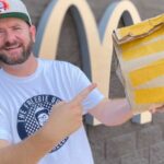 Man happily holding a McDonald's meal, representing food deals