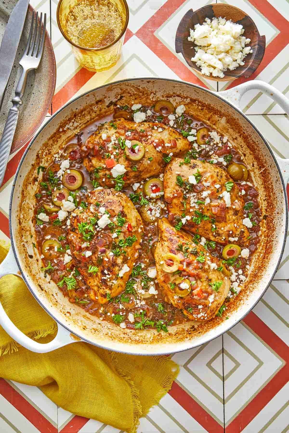 Mediterranean chicken with tomatoes and olives in a skillet, ready to serve.